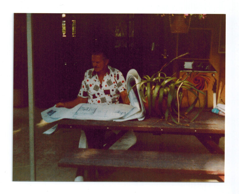 Architect and master builder reviewing custom estate plans and structural specifications