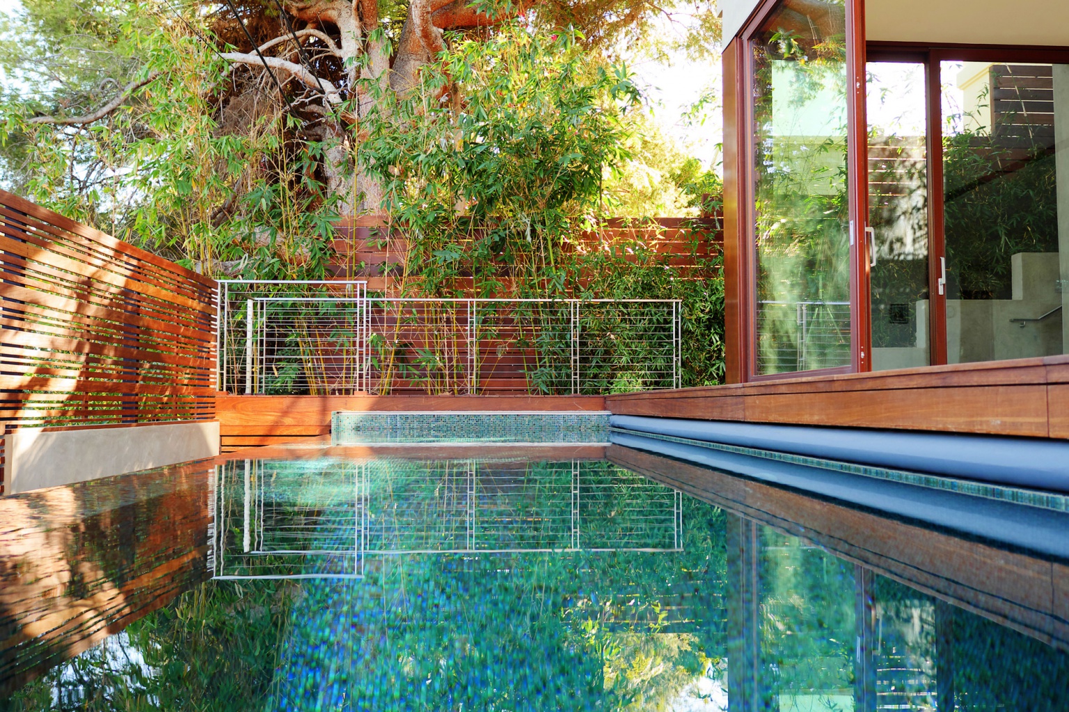 Seamless indoor-outdoor luxury living space with vanishing doors and custom pool